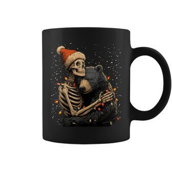 Skeleton Hugging Bear Santa Hat Snow Gothic Christmas Coffee Mug - Monsterry