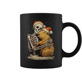 Skeleton Hugging Capybara Santa Hat Snow Gothic Christmas Coffee Mug - Monsterry