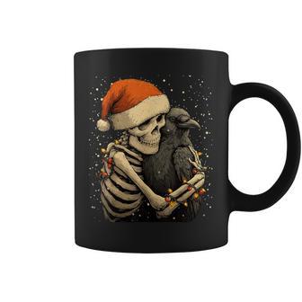 Skeleton Hugging Crow Santa Hat Snow Snowy Gothic Christmas Coffee Mug - Monsterry