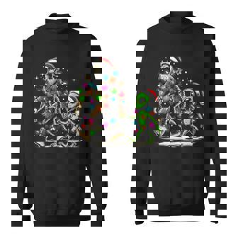 Alien And Bigfoot Wearing A Santa Hat And Christmas Lights Sweatshirt | Mazezy