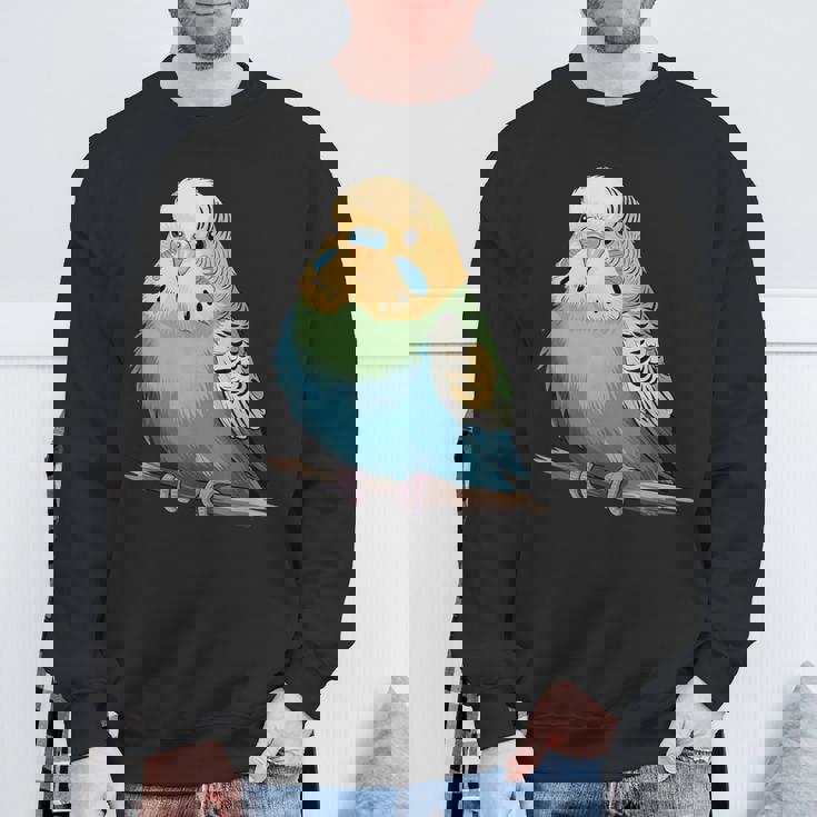 枝に腰掛けたチャーミングなセキセイインコ スウェットシャツ 高齢者への贈り物