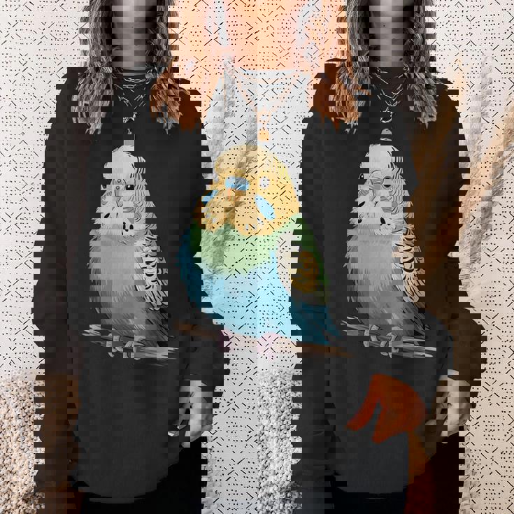 枝に腰掛けたチャーミングなセキセイインコ スウェットシャツ 彼女への贈り物