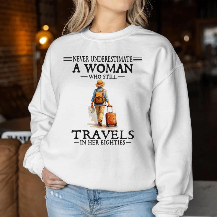 Never Underestimate A Woman Who Still Travels In Her 80'S Women Sweatshirt Funny Gifts