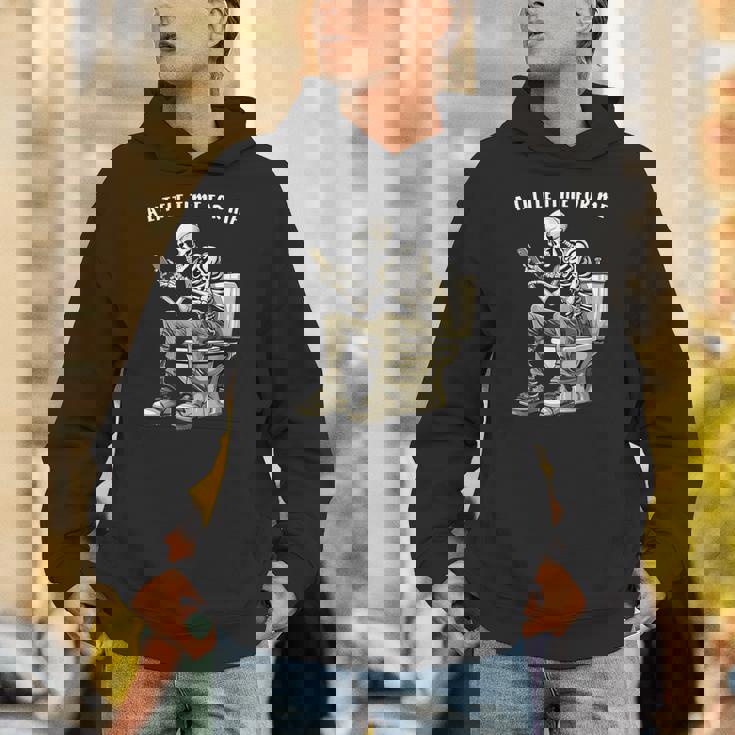 スマートフォン付きトイレのスケルトン ゴシックユーモア パーカー