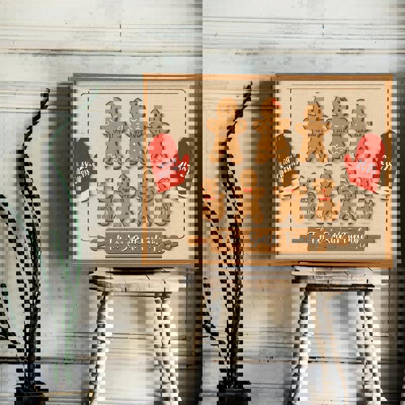 Gingerbread family canvas wall art featuring snowflake accents, custom grandkids' names on cookies, festive Christmas decor