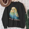 枝に腰掛けたチャーミングなセキセイインコ スウェットシャツ 年配の女性への贈り物